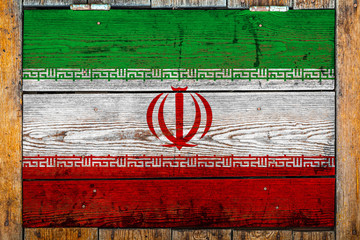 National flag of Iran on a wooden wall background.The concept of national pride and symbol of the...