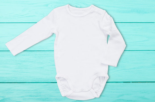 White baby mock up jumpsuit on blue wooden background. Baby bodysuit mockup  and template blank copy space. Top Front view. One-piece newborn shirt  clothes mock-up. Stock Photo | Adobe Stock