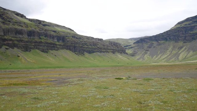 canyons of basaltic rocks in iceland. A beautiful Icelandic valley. A volcanic landscape covered with grass. Iceland