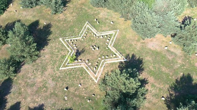 Star of David aerial video of jewish symbol. Rotating around old jewish cemetery in eastern europe. 