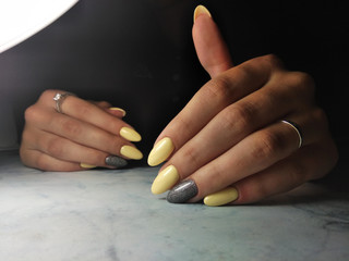 Yellow gel polish with grey design and sequins