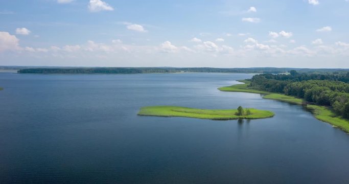 Aerial timelapse of beautiful nature. Drone flying over large lake. Shot in Braslaw Lakes national park in Belarus. Summer season