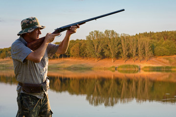 Fototapeta premium Hunter with a german drathaar and spaniel, pigeon hunting with dogs in reflective vests 