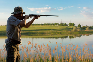 Hunter with a german drathaar and spaniel, pigeon hunting with dogs in reflective vests	