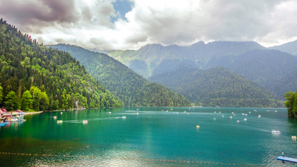 Natural landscape. Panorama view of the lake Small Ritsa. Trees reflecting in the blue from lapis...