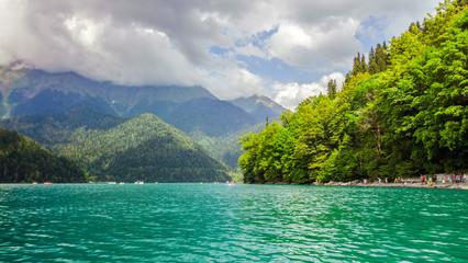 Natural landscape. Panorama view of the lake Small Ritsa. Trees reflecting in the blue from lapis lazuli water. Ritsa National Park, Abkhazia