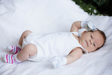 portrait of a baby lying on bed