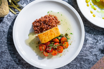 Top view salmon grilled fillet with bulgur with tomato on marble table. Flat lay food. Restaurant seafood for lunch. Salmon fish steak. Delicious and tasty
