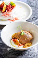 Selective focus on tasty chocolate ice cream with sea salt and microgreen. Restaurant style modern ice cream. Sweet dessert after lunch. Flat lay marble table. Two tasty desserts