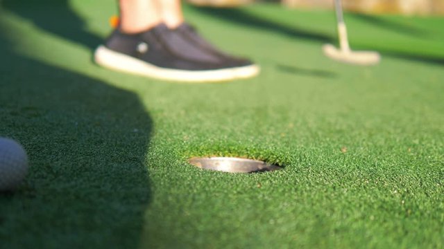 Golf ball missing a hole in 4k slow motion 60fps