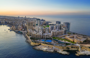 Sliema city. Aerial view of Tigne Point complex building, apartment. Evening, Sunset. Malta