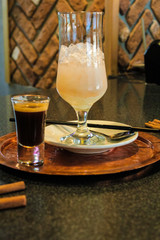 A drink consisting of Baileys liqueur and a drink of mineral water, sweet syrup with ice and a straw. European recipe