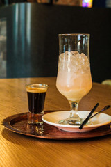 A drink consisting of Baileys liqueur and a drink of mineral water, sweet syrup with ice and a straw. European recipe