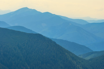 Fototapeta premium mountain ridge silhouette in a blue mist, natural background