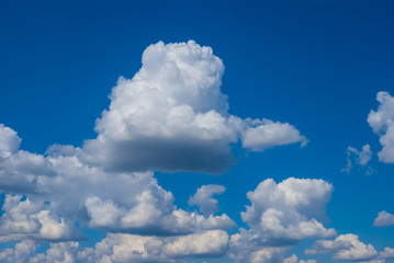 Naklejka na ściany i meble beautiful cumulus clouds on a blue sky, nice natural background