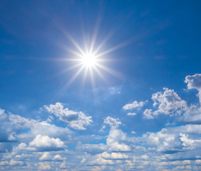 Naklejka na ściany i meble beautiful natural background, blue sky with clouds and sparkle sun