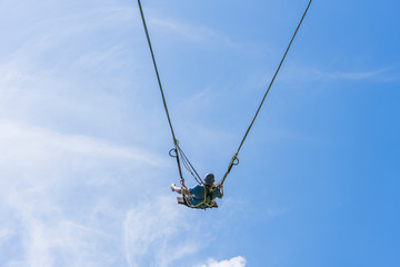 Man swinging a swing in jungle on rice terraces, island Bali, Ubud, Indonesia