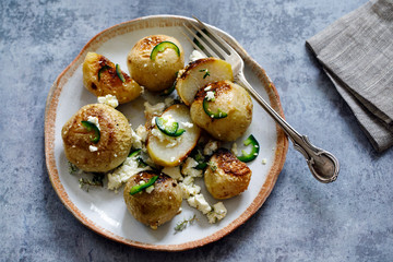 Whole roasted kohlrabi with feta cheese and jalapenos