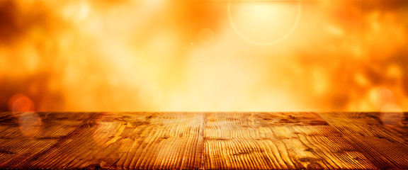 Wooden table with blurred golden bokeh background