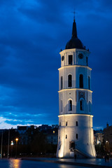Fototapeta na wymiar Vilnius, Lithuania. The View Of Cathedral Square With Bell Tower And Cathedral Basilica Of St. Stanislaus And St. Vladislav in summer at night with blue sky after the rain, vertical