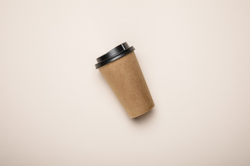 top view of coffee to go on beige background