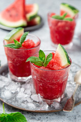 watermelon granita or sorbet with mint and fresh watermelon slices in glass