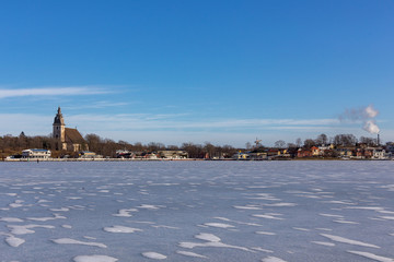 Fototapeta premium Frozen sea in Naantali Finland. Beautiful sunny winter day with blue sky.