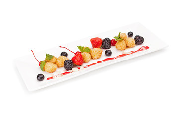 The meat or fish croquets fried in oil given with berries of strawberry, a mulberry and blackcurrant, decorated with mint leaves.