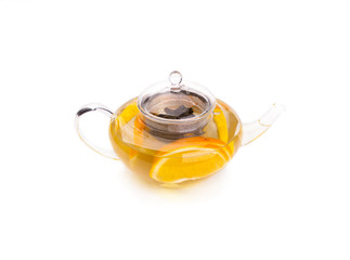 Teapot with herbal tea with an orange slices