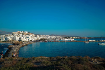 Fototapeta na wymiar 2 men playing bouzouki surrounded by the beauty of the island of Naxos