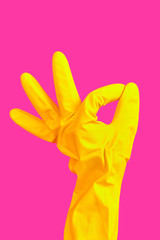 Hand gesture OK in yellow rubber glove isolated on pink background. cleaner hand shows OK gesture. Minimalism poster concpet. Copy space