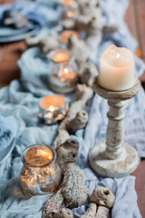 table setting with candles and blue tissue