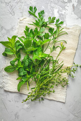 Herbs and spices. Fresh herbs selection included rosemary, thyme, mint, lemon balm, parsley and arugula. Overhead view, copy space.