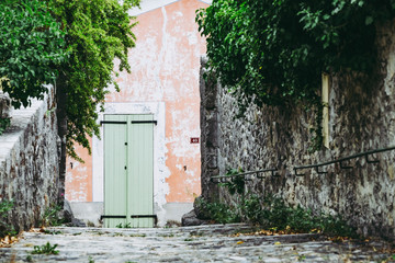 Ruelle d'un village français avec un escalier en pierre et porte en bois