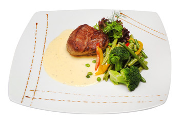 Pork meat grilled with fresh vegetable salad on a white plate. a top view of a horizontal