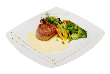 Pork meat grilled with fresh vegetable salad on a white plate. a top view of a horizontal