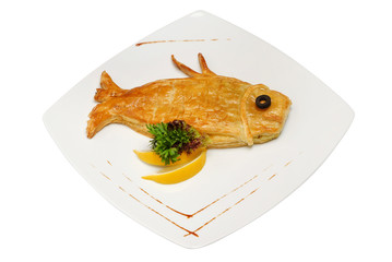 Loaf in the form of fish. Fish-shaped cake on white background. Ruddy fish pie isolated on white isolated background