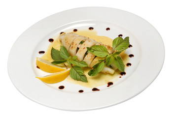 Grilled squid stuffed with vegetables closeup on plate on white isolated background