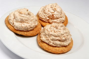Tasty cookies with meringue on plate on gray background