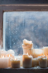 Fototapeta na wymiar burning candles on windowsill