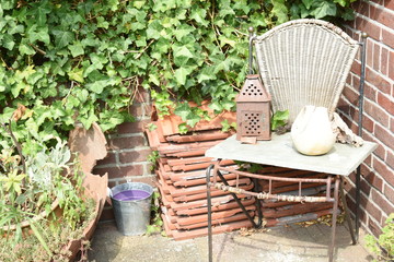 Fototapeta premium junk corner with chair and tiles and ivy