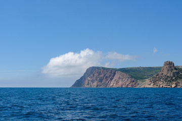 the endless expanses of the black sea, rich blue, on a bright sunny day with clouds in the sky, from the side of a pleasure boat in the black sea.