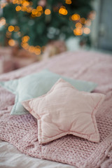 Fototapeta na wymiar bed with pink and gray bedding and star shaped pillows