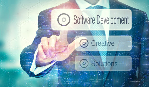 A businessman selecting a Software Development button on a futuristic display with a concept written on it.