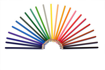 Rainbow from set of colored pencils in a hand fan form on white background