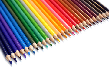 Rainbow from set of colored pencils on white background close up view