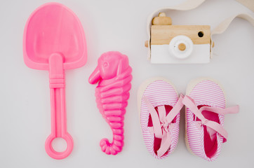 Top view baby shoes with pink toys