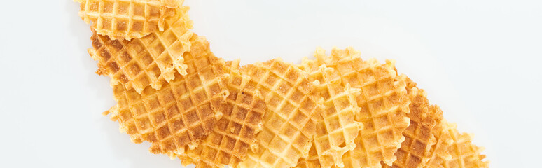 panoramic shot of crispy waffles on white