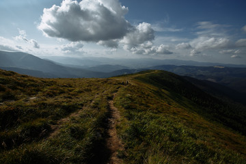 clouds floating on a sharp line of blue mountains