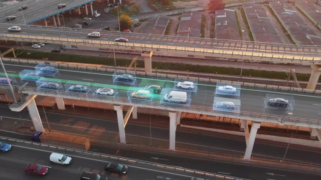 Beautiful aerial presentation of self-driving cars concept on multi-level highway in Moscow. Picturesque aerial panorama of autonomous cars in the road traffic of big city on the evening.